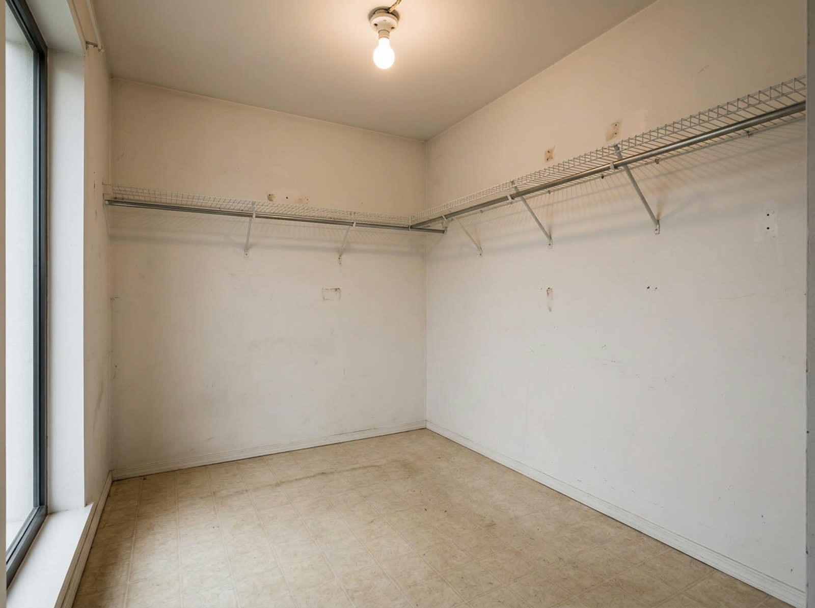 Standard closet before a custom storage system was installed